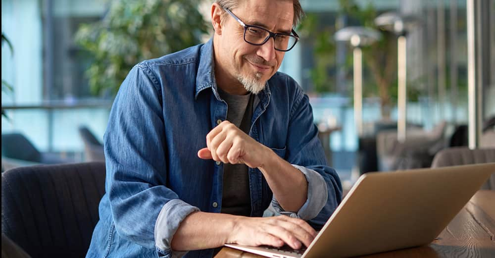 man creating receipt on laptop