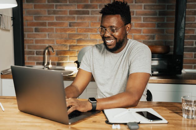 smiling man on computer