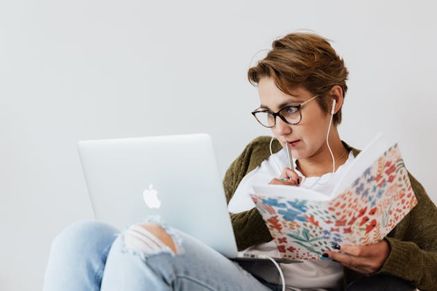 woman thinking with notebook and laptop