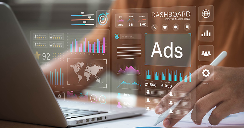 Person-working-at-a-desk-with-an-overlay-of-images-on-them-showing-a-dashboard-of-ad-campaign-metrics.